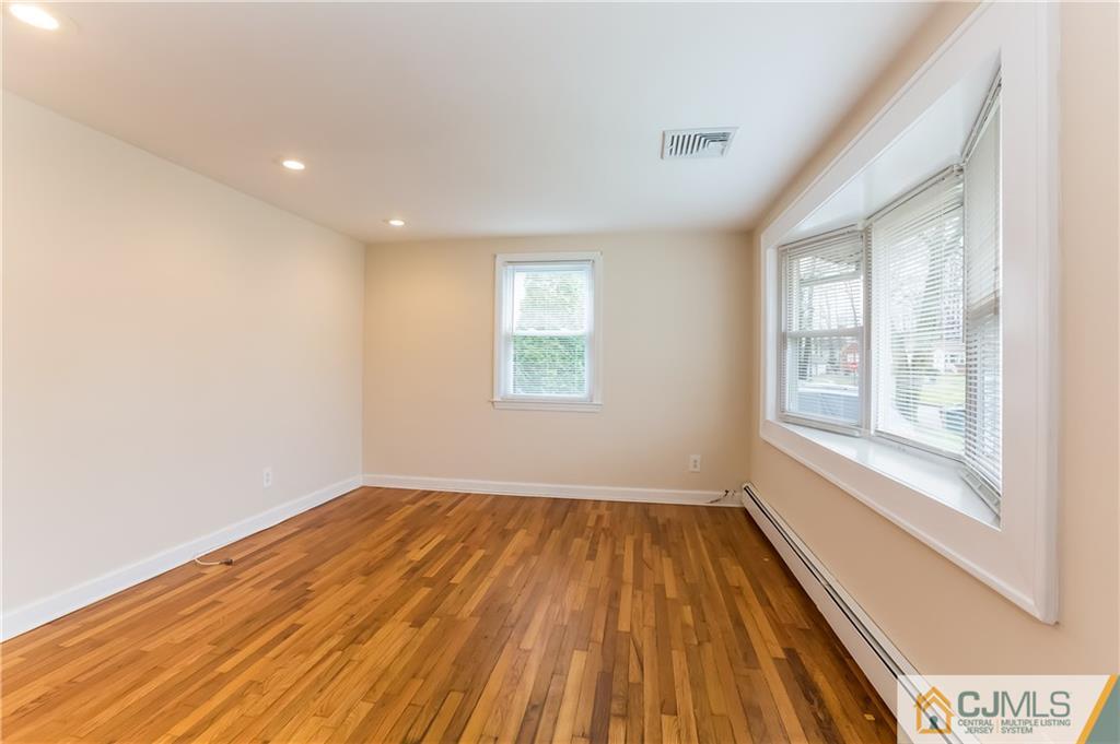 41 West Cliff Road Colonia, NJ 07067 - Photo 16 of 23 a view of a room with wooden floor and windows
