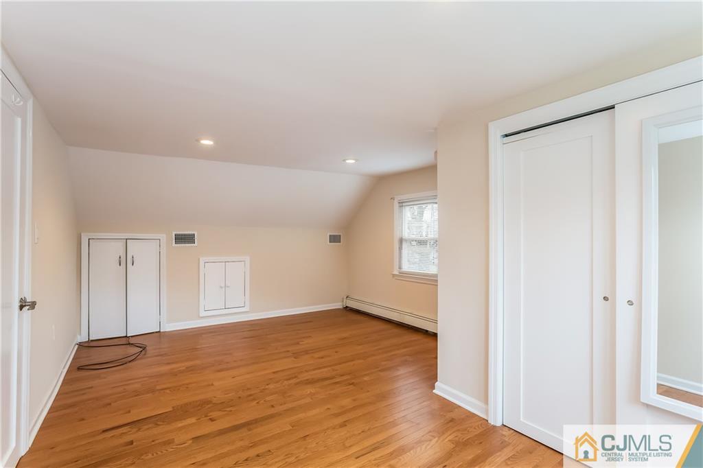 41 West Cliff Road Colonia, NJ 07067 - Photo 18 of 23 a view of empty room with wooden floor and fan