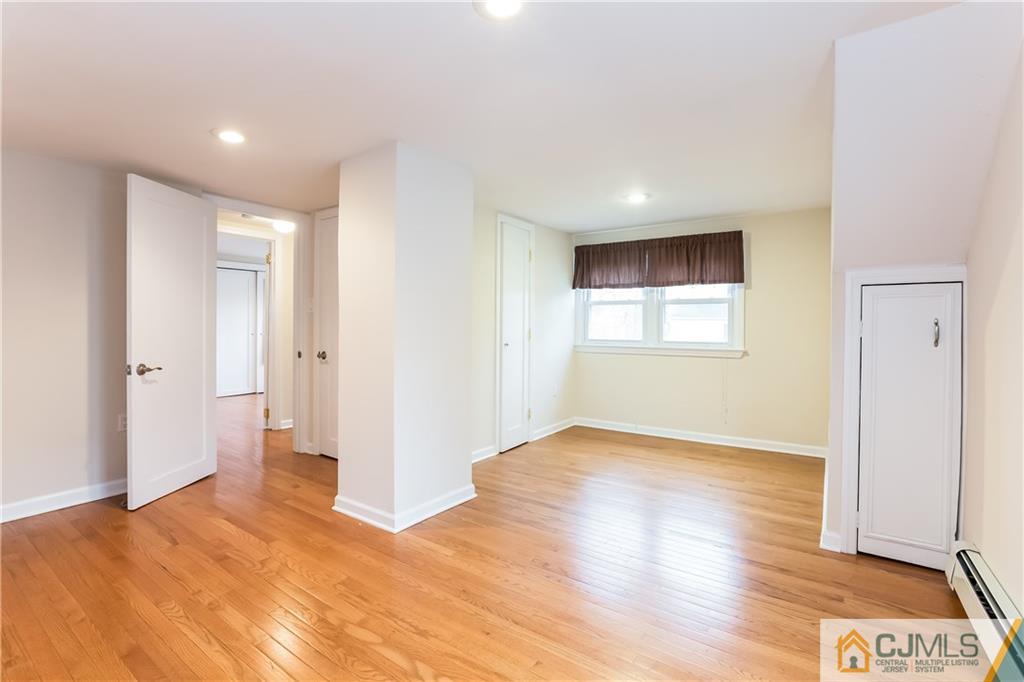 41 West Cliff Road Colonia, NJ 07067 - Photo 20 of 23 a view of empty room with wooden floor and fan