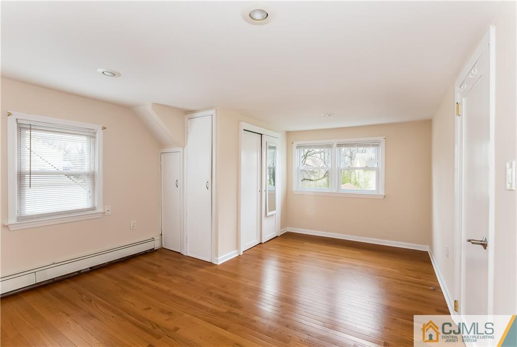 41 West Cliff Road Colonia, NJ 07067 - Photo 22 of 23 an empty room with wooden floor and windows