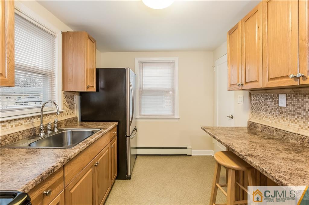 41 West Cliff Road Colonia, NJ 07067 - Photo 5 of 23 a kitchen that has a sink and a stove