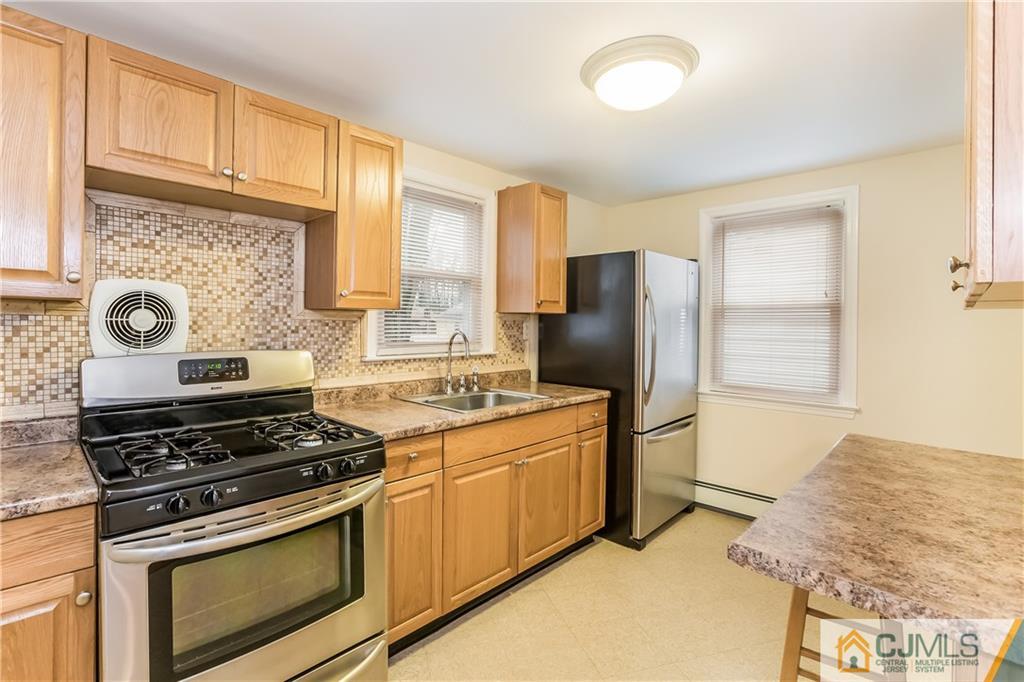 41 West Cliff Road Colonia, NJ 07067 - Photo 6 of 23 a kitchen with stainless steel appliances granite countertop a stove a refrigerator and a stove