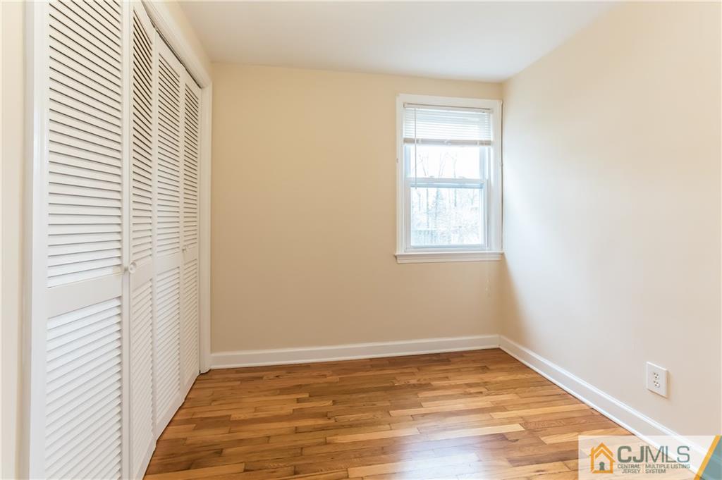 41 West Cliff Road Colonia, NJ 07067 - Photo 9 of 23 a view of an empty room with wooden floor and a window