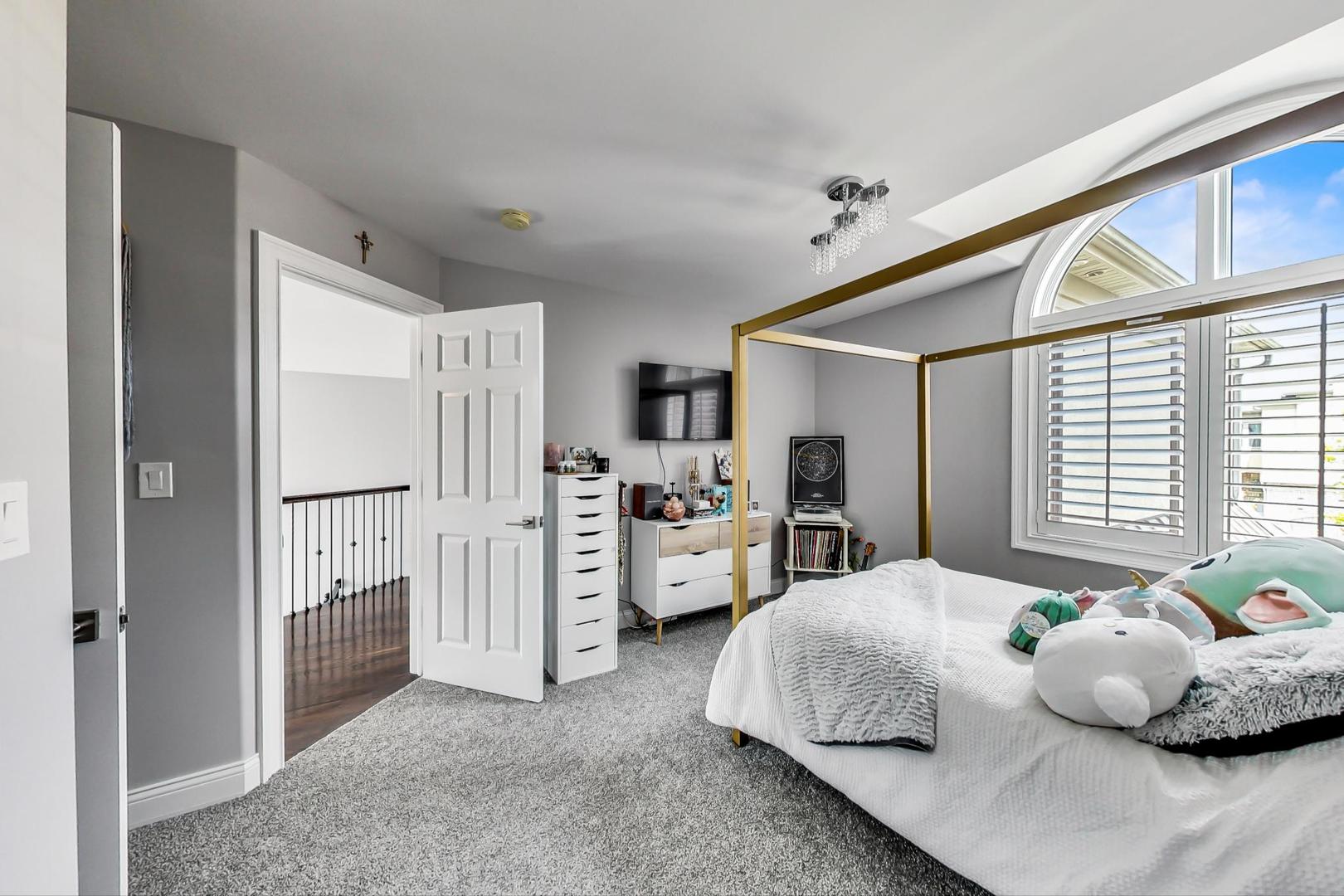 1415 Rue Paris Place Inverness, IL 60067 - Photo 21 of 35 a spacious bedroom with a bed and a window