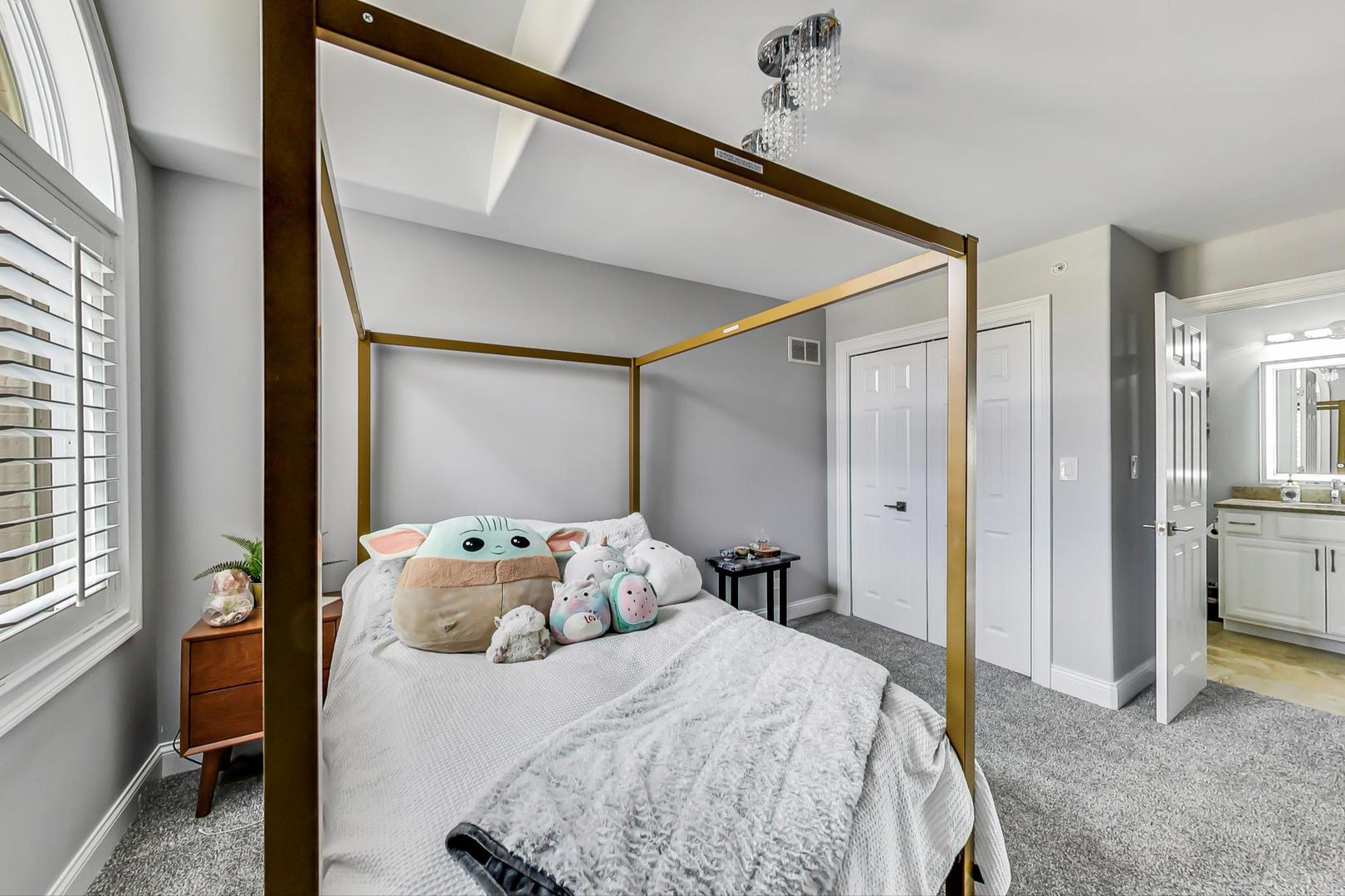 1415 Rue Paris Place Inverness, IL 60067 - Photo 22 of 35 a bedroom with a bed and a mirror