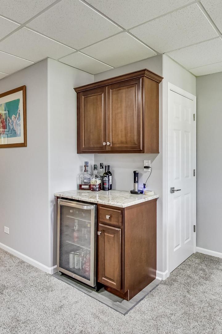 1415 Rue Paris Place Inverness, IL 60067 - Photo 27 of 35 a kitchen with stainless steel appliances granite countertop a sink and a stove top oven