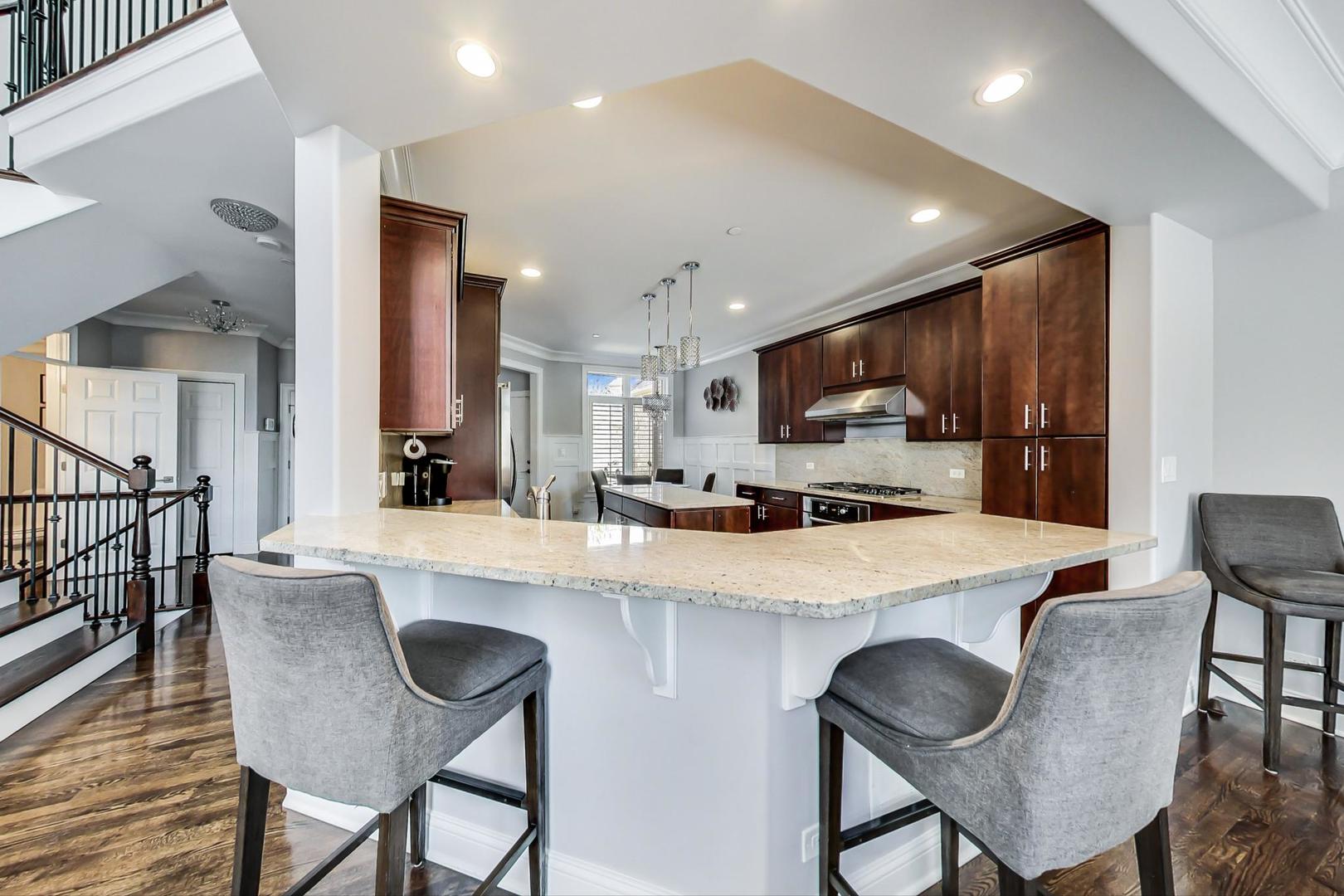 1415 Rue Paris Place Inverness, IL 60067 - Photo 10 of 35 a large kitchen with a table and chairs