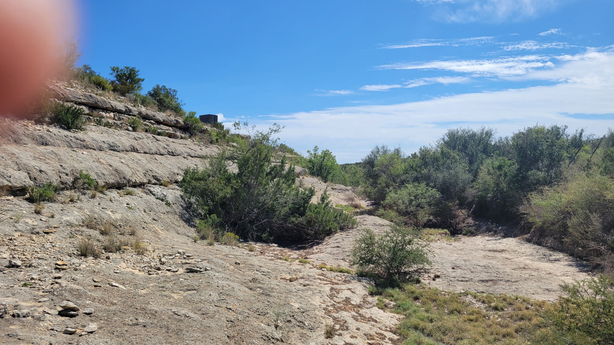 -bendle Rd Bendle Road Dryden, TX 78851 - Photo 10 of 31 Natural rock ledges and native vegetation line this rugged canyon landscape under blue skies.