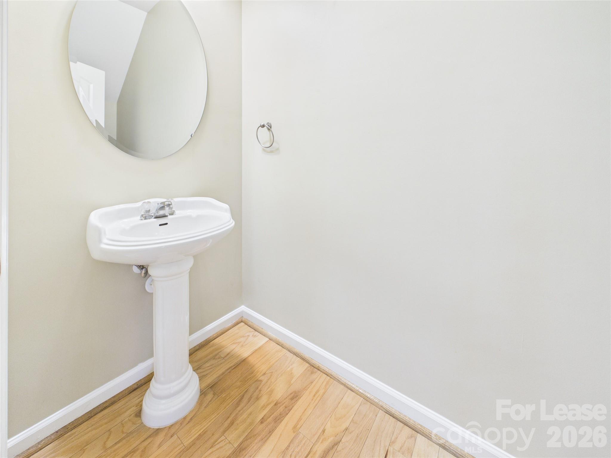 5690 Stafford Road Charlotte, NC 28215 - Photo 9 of 25 a bathroom with a sink and a mirror