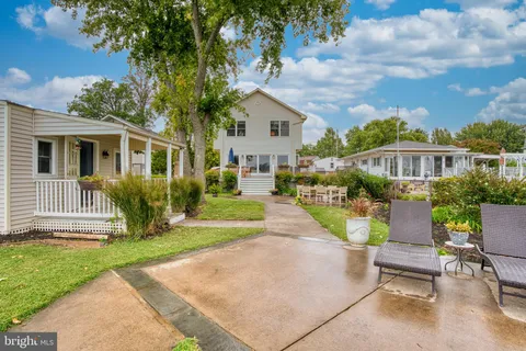 a front view of a house with a yard garage and outdoor seating