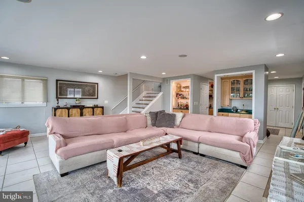 a kitchen with stainless steel appliances granite countertop a stove a sink a refrigerator and chairs