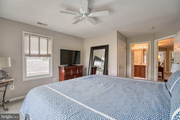 a view of a patio with a dining table and chairs with wooden floor next to a yard