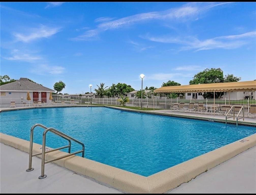 8305 Northwest 61st Street, Unit 203 Tamarac, FL 33321 - Photo 11 of 13 a view of swimming pool with seating space and deck