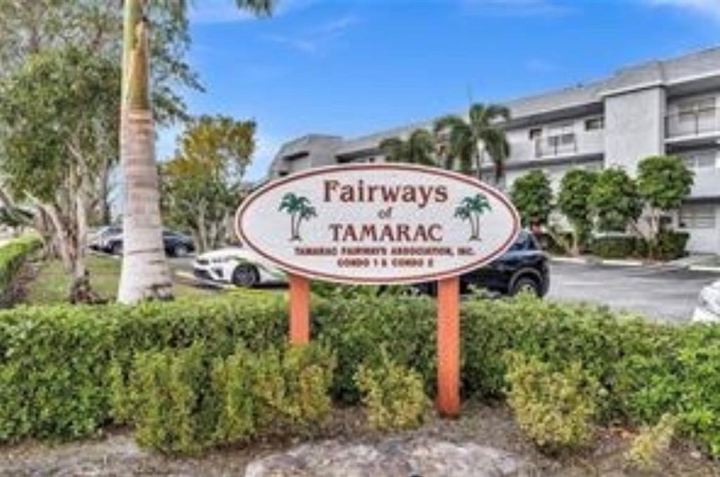 8305 Northwest 61st Street, Unit 203 Tamarac, FL 33321 - Photo 13 of 13 a view of a sign board with a pool
