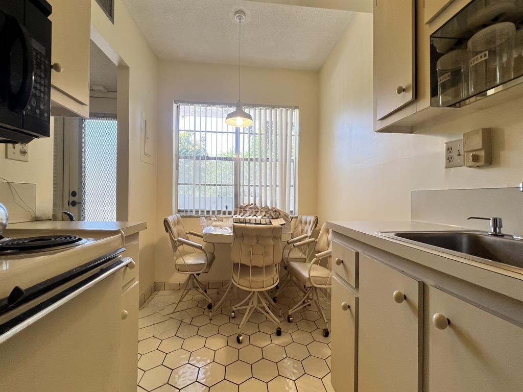 8305 Northwest 61st Street, Unit 203 Tamarac, FL 33321 - Photo 2 of 13 a dining room with furniture and window