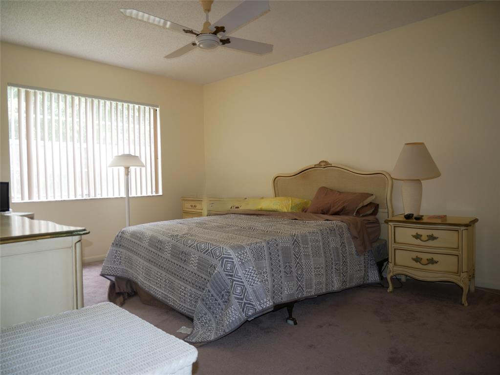 8305 Northwest 61st Street, Unit 203 Tamarac, FL 33321 - Photo 8 of 13 a bedroom with a bed and a window