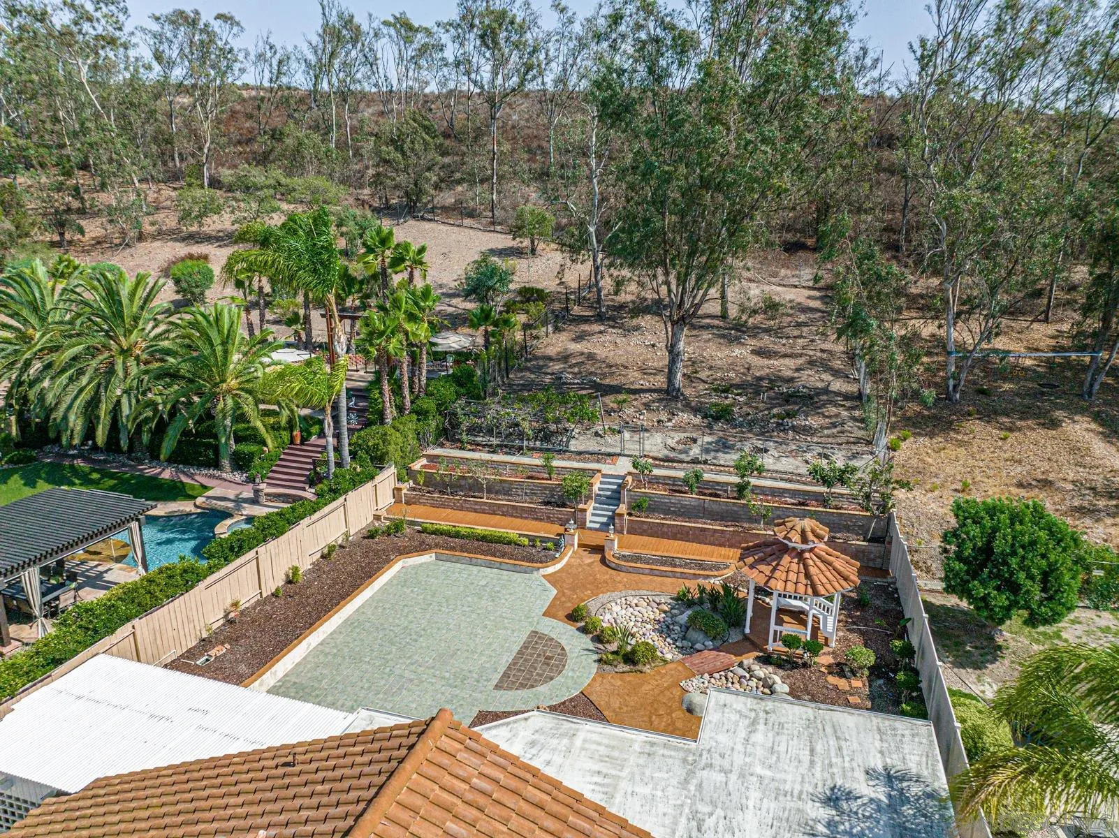 13893 Carriage Road Poway, CA 92064 - Photo 1 of 71 a view of swimming pool with lounge chair and trees in the background
