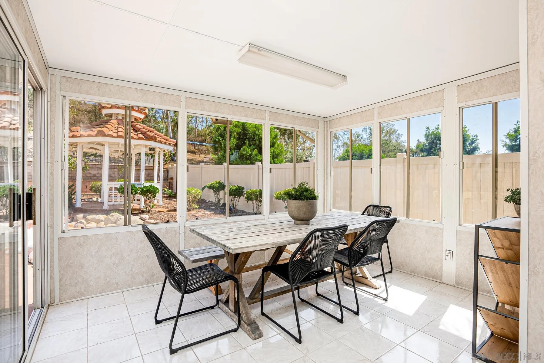 13893 Carriage Road Poway, CA 92064 - Photo 25 of 71 a view of a dining room with furniture large windows and wooden floor