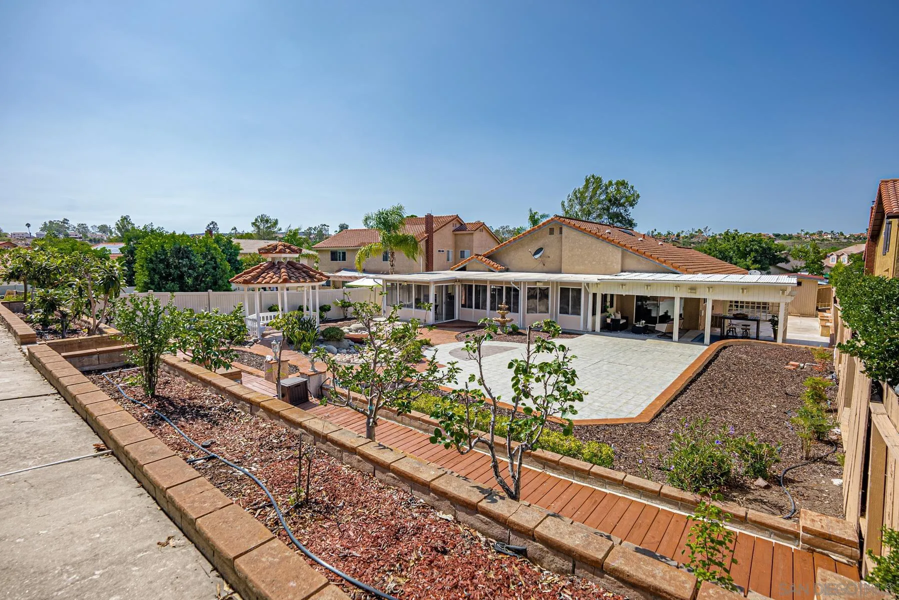 13893 Carriage Road Poway, CA 92064 - Photo 50 of 71 a front view of a house with a garden and balcony