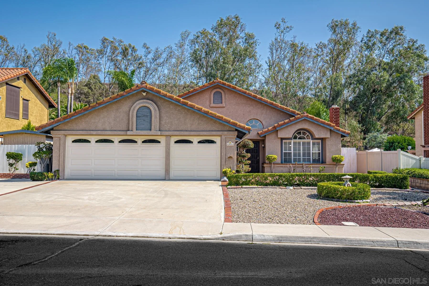 13893 Carriage Road Poway, CA 92064 - Photo 59 of 71 a front view of a house with a yard and garage