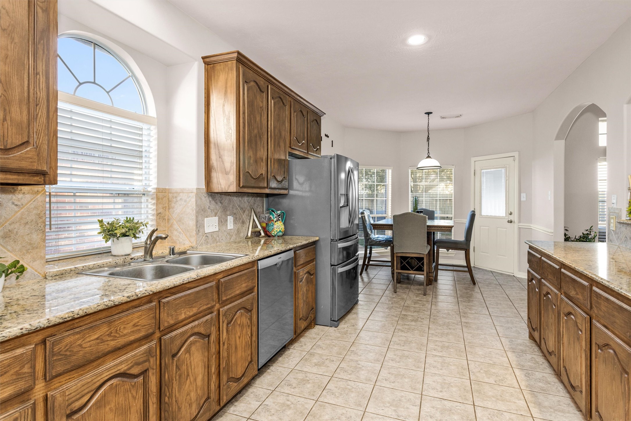 30110 Legends Ridge Drive Spring, TX 77386 - Photo 19 of 49 a kitchen with granite countertop a sink a counter space appliances and cabinets