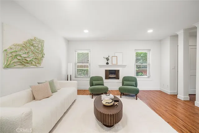 a view of a dining room with furniture wooden floor and a chandelier