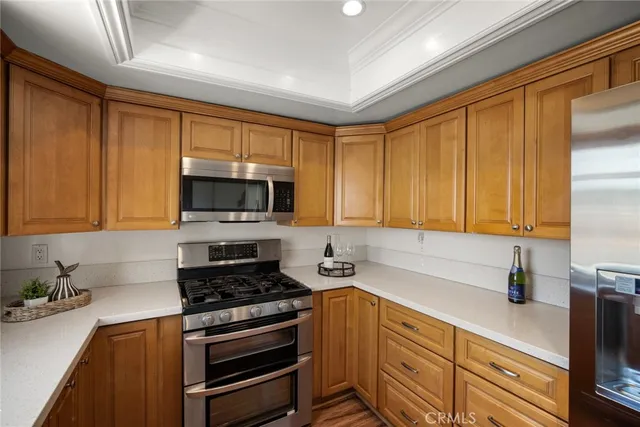 a kitchen with stainless steel appliances a stove a sink and a microwave