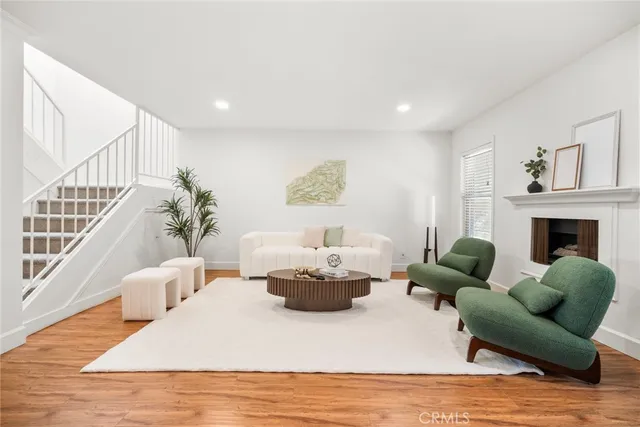 a living room with furniture potted plant and a fireplace