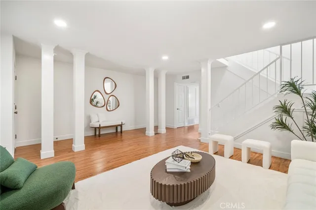 a living room with furniture and a floor to ceiling window