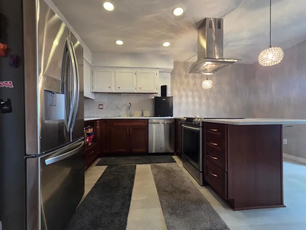 a kitchen with a sink refrigerator and cabinets