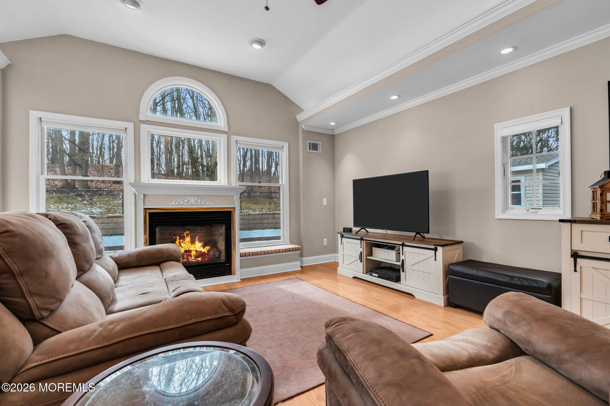 48 Newbury Road Howell, NJ 07731 - Photo 11 of 41 a living room with furniture a flat screen tv and a fireplace