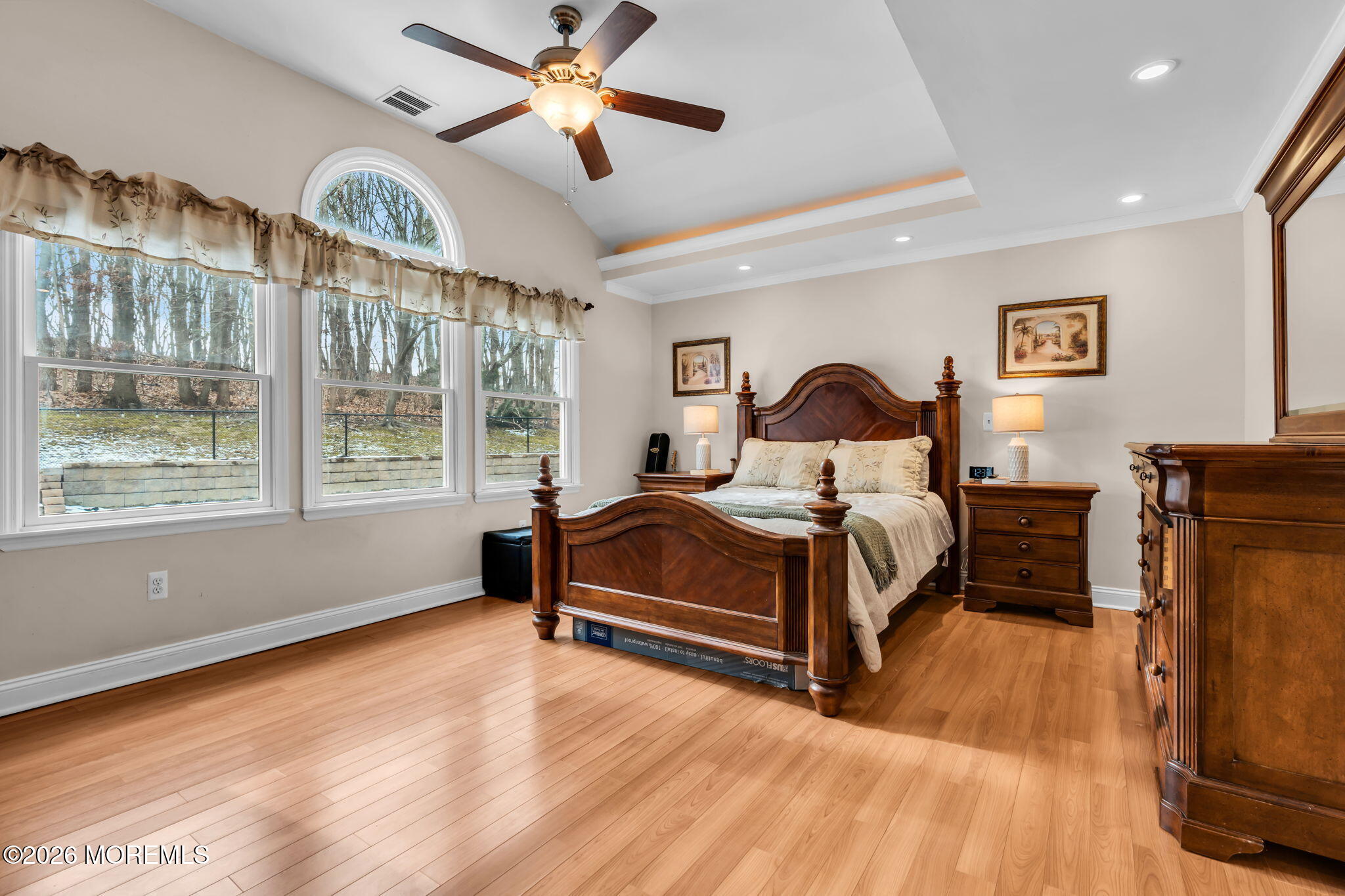 48 Newbury Road Howell, NJ 07731 - Photo 12 of 41 a bedroom with a large bed and a chandelier