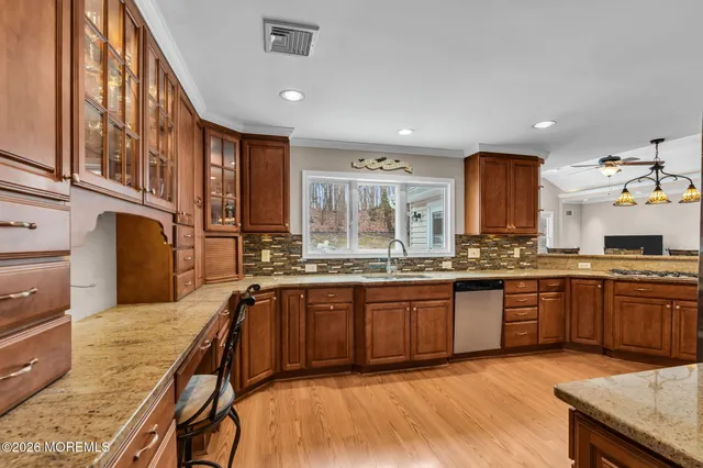 a large kitchen with stainless steel appliances granite countertop a stove and a sink