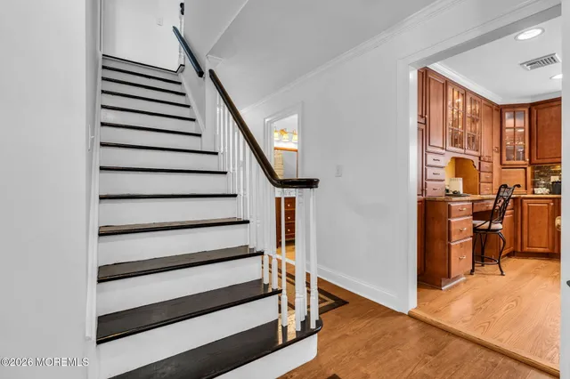 a view of entryway and hall with wooden floor