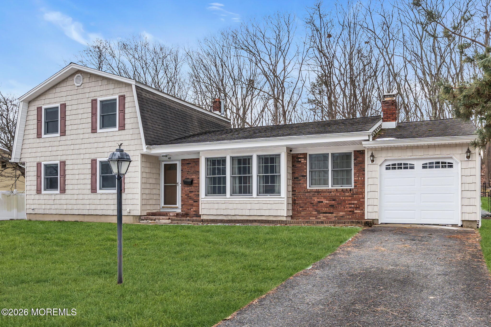 48 Newbury Road Howell, NJ 07731 - Photo 2 of 41 a front view of a house with a yard and trees