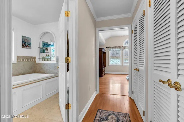 a en suite bathroom with a sink and mirror with bathtub