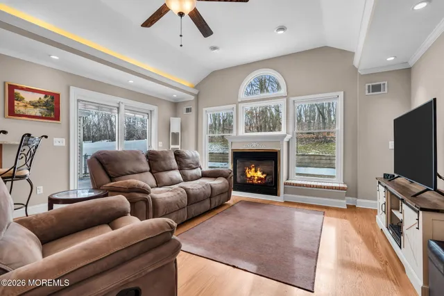 a living room with furniture a flat screen tv and a fireplace