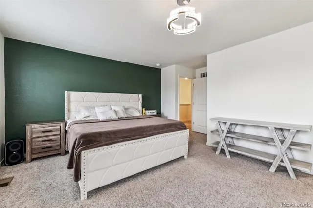 a bedroom with a bed and a chair