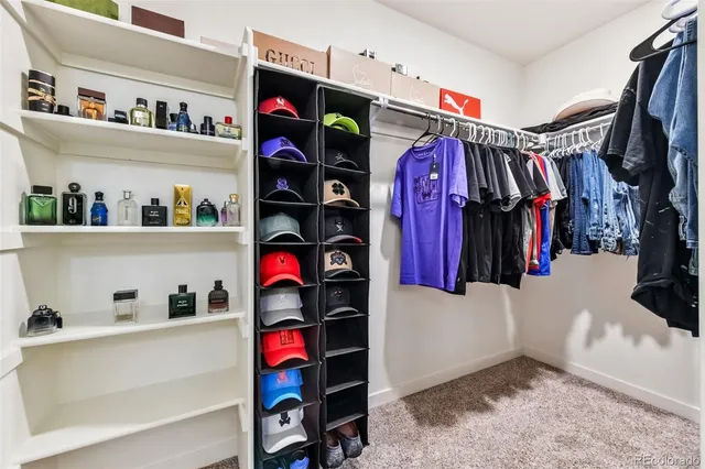 a view of walk in closet with clothes and shoes