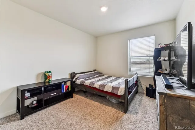 a bed room with a bed and a window