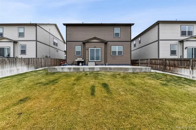 a swimming pool covered with buildings in the background