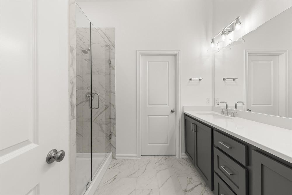 1237 Doris May Drive Allen, TX 75013 - Photo 16 of 19 Bathroom featuring a glass-enclosed shower with tiled walls and flooring