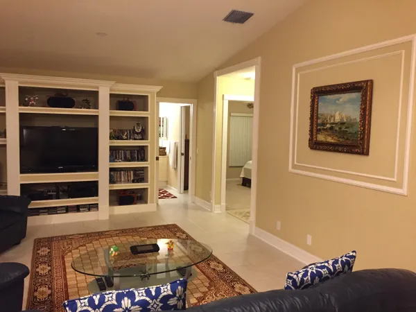a living room with furniture and a chandelier