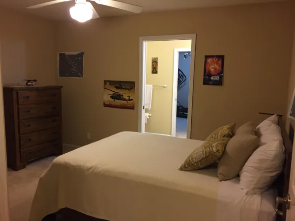 a bedroom with a bed and a dresser