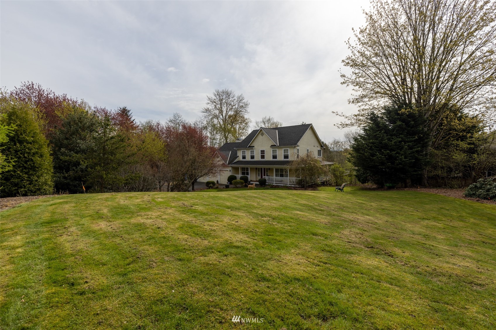 24121 Locust Way Bothell, WA 98021 - Photo 6 of 12 a front view of a house with a garden