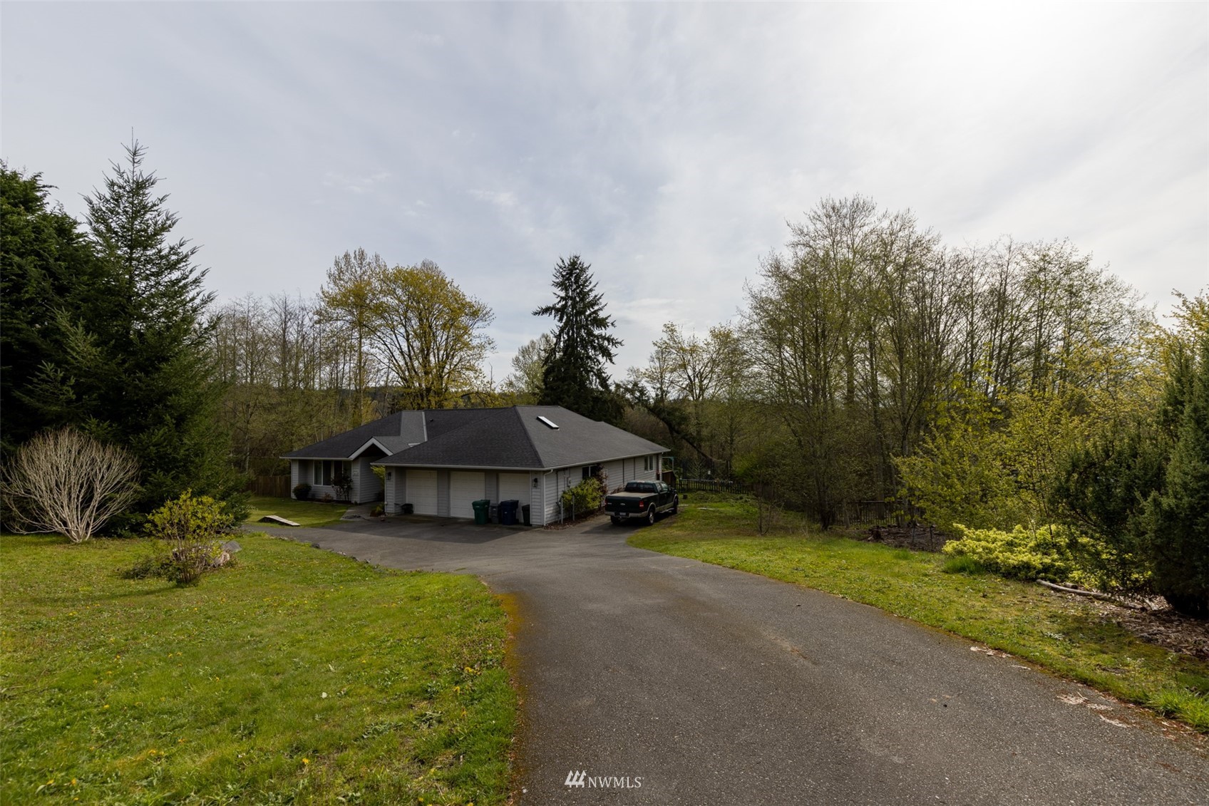24121 Locust Way Bothell, WA 98021 - Photo 7 of 12 a view of a house with backyard and trees