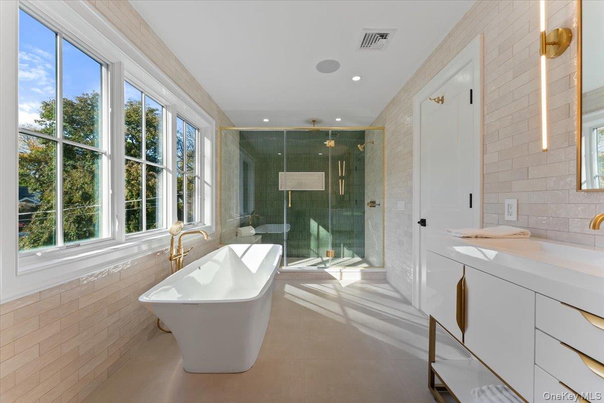 50 Franklin Avenue Rye, NY 10580 - Photo 18 of 45 a bathroom with a tub a sink a mirror and a shower