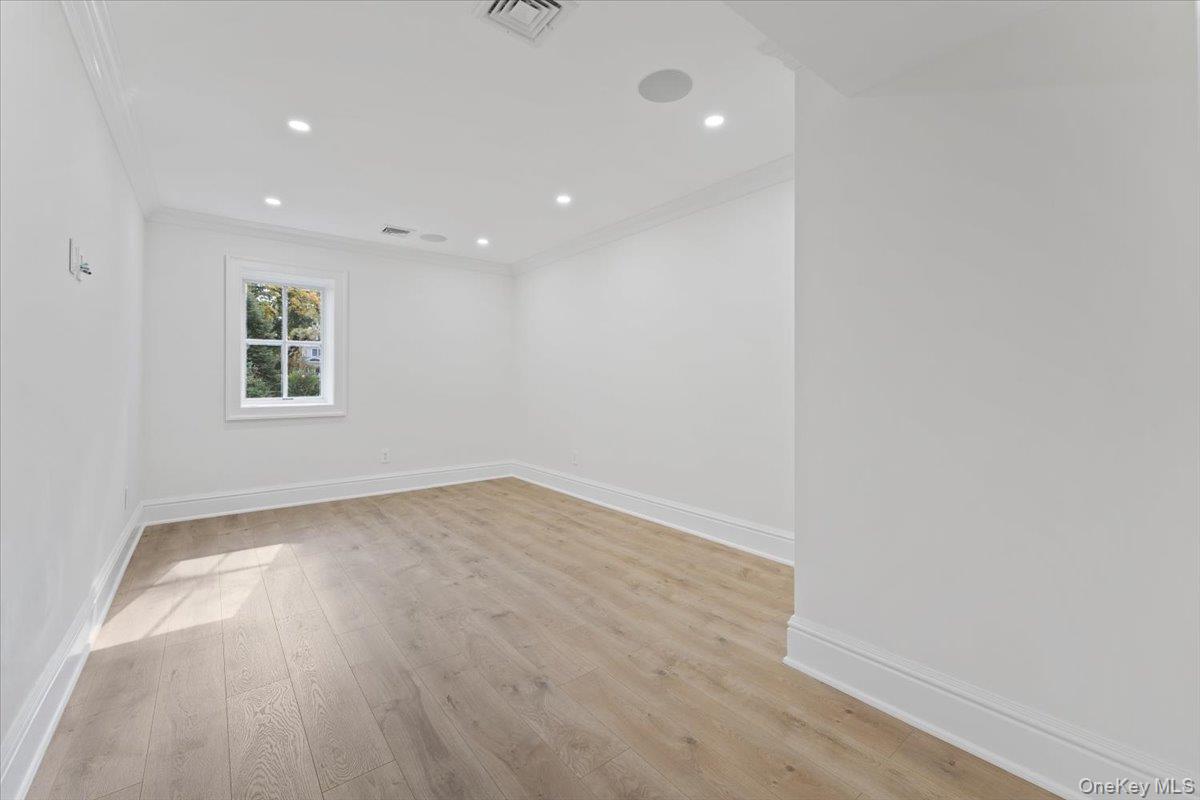 50 Franklin Avenue Rye, NY 10580 - Photo 28 of 45 an empty room with wooden floor and windows