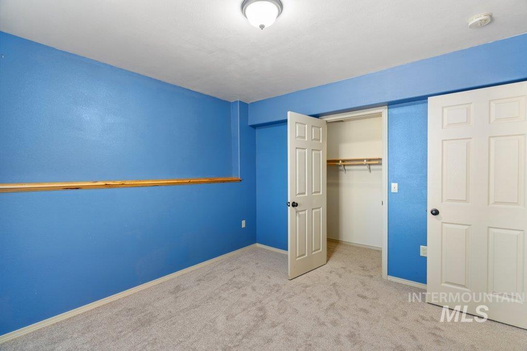 1028 Granlund Road Troy, ID 83871 - Photo 42 of 46 Plush carpeting, paneled doors, and a built-in closet with shelving