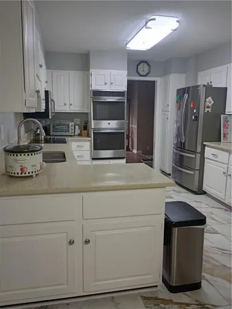 a kitchen with cabinets and stainless steel appliances